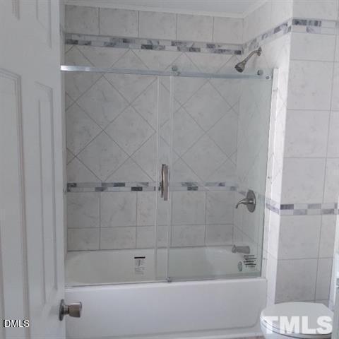 1017 Holmes Street Raleigh, NC 27601 - Photo 9 of 11 a bathroom with a shower and a toilet