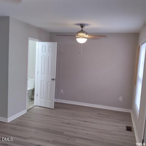 1017 Holmes Street Raleigh, NC 27601 - Photo 10 of 11 an empty room with wooden floor and window