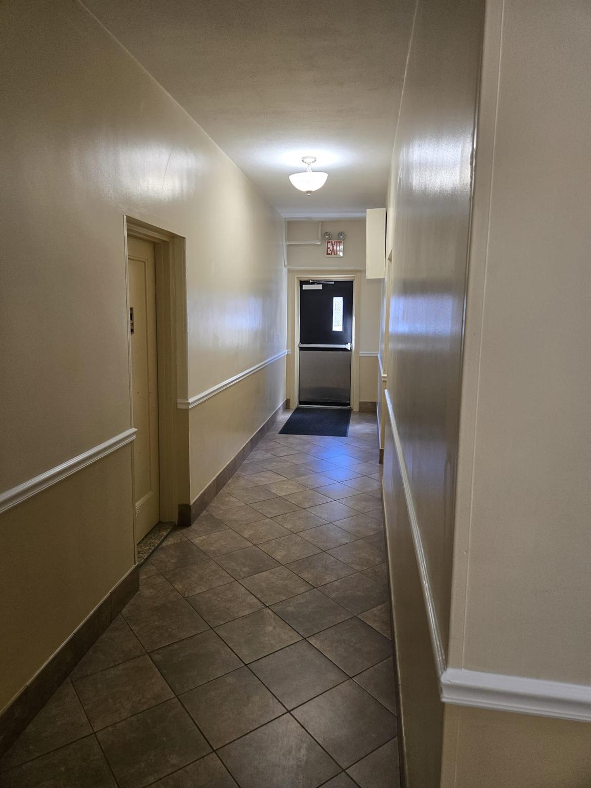 801 Bronx River Road, Unit 2G Bronxville, NY 10708 - Photo 1 of 18 Hall with baseboards and dark tile patterned flooring