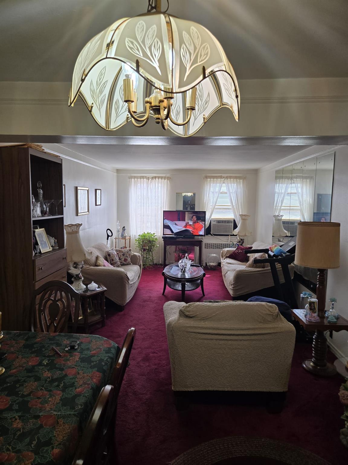 801 Bronx River Road, Unit 2G Bronxville, NY 10708 - Photo 11 of 18 Living area with carpet flooring, an inviting chandelier, and a healthy amount of sunlight