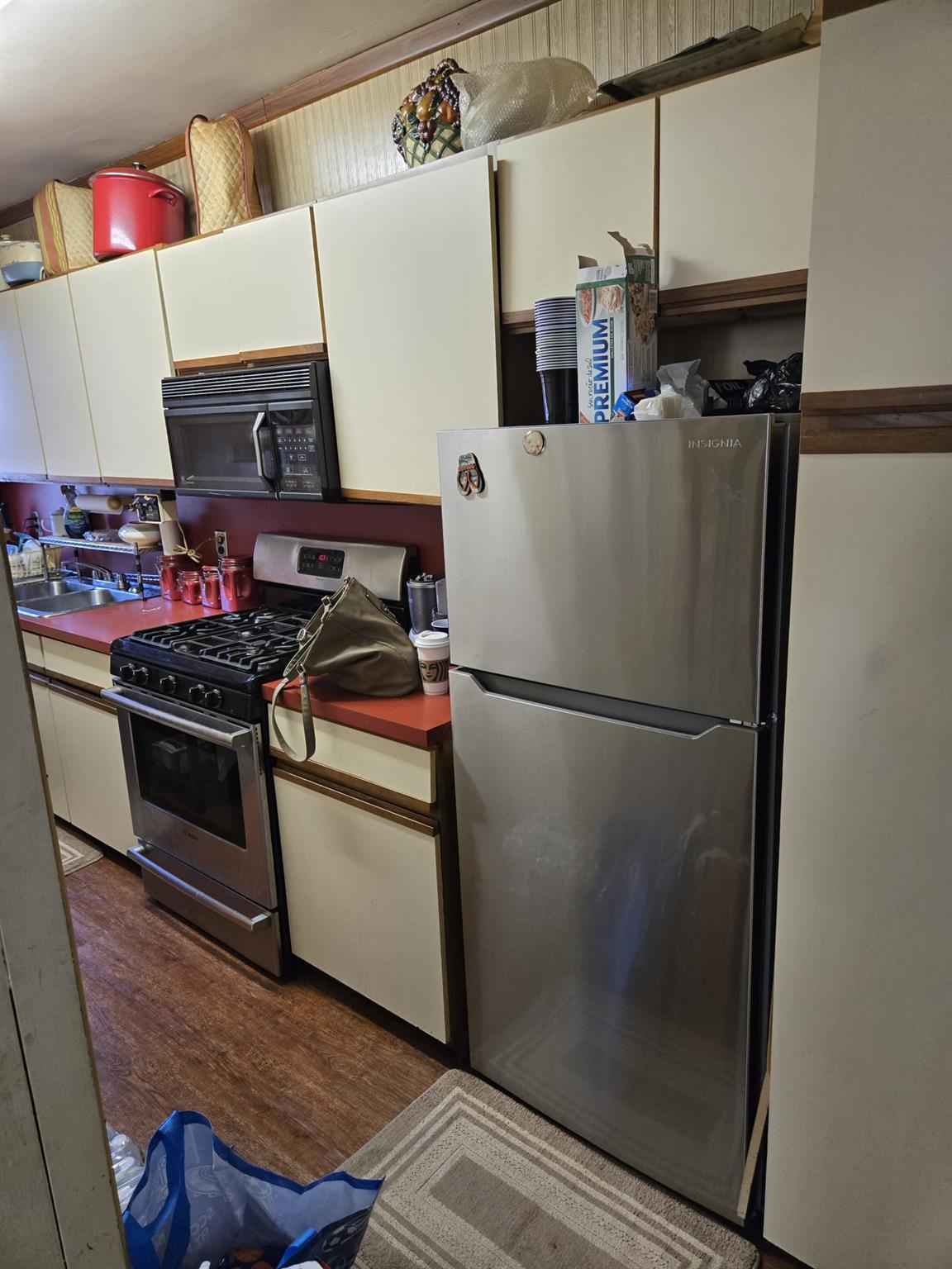801 Bronx River Road, Unit 2G Bronxville, NY 10708 - Photo 14 of 18 Kitchen featuring stainless steel appliances, a sink, dark countertops, white cabinets, and wood finished floors
