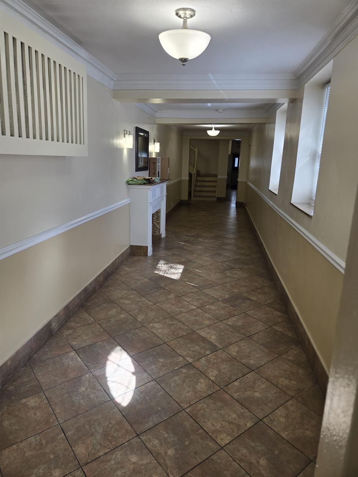 801 Bronx River Road, Unit 2G Bronxville, NY 10708 - Photo 4 of 18 Hallway with ornamental molding, baseboards, and stairway
