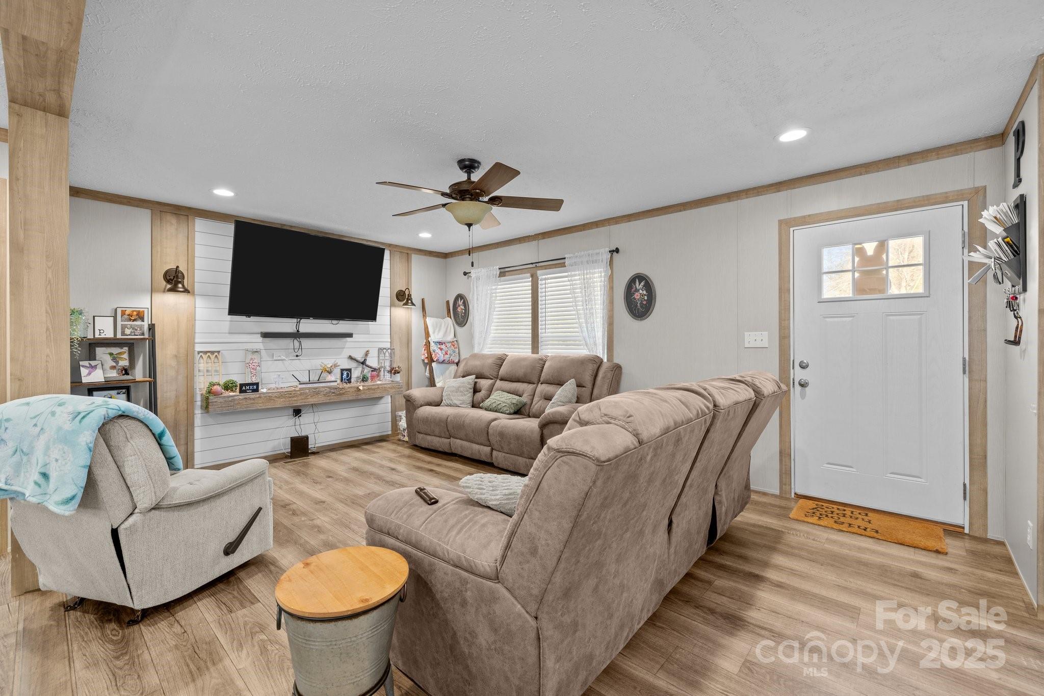 119 Old Hearth Road Clover, SC 29710 - Photo 8 of 39 a living room with furniture ceiling fan and a wooden floor