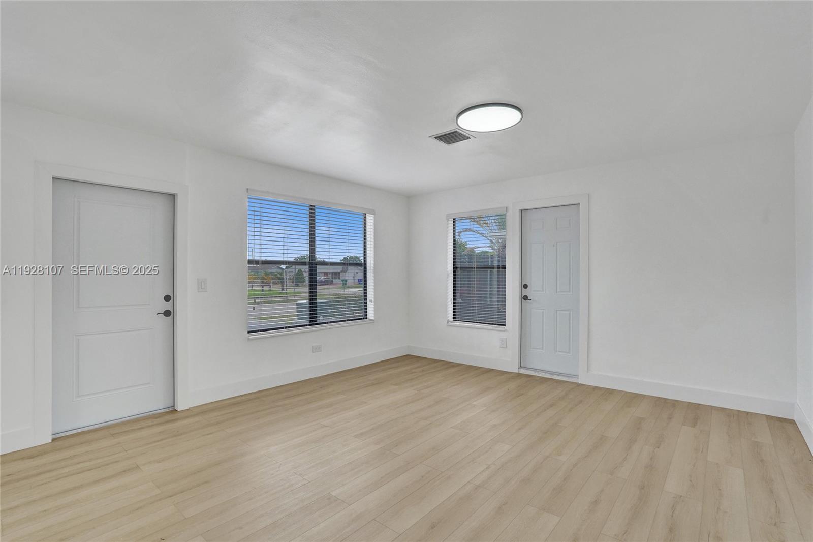 1960 Southwest 68th Way Miramar, FL 33023 - Photo 12 of 42 wooden floor in an empty room with a window