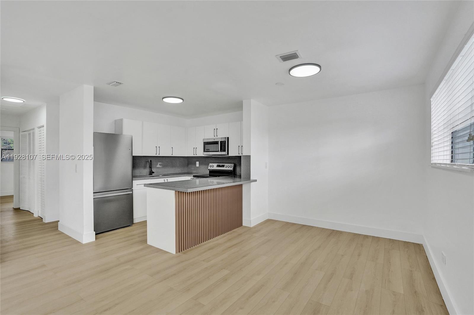 1960 Southwest 68th Way Miramar, FL 33023 - Photo 14 of 42 a kitchen with stainless steel appliances granite countertop a refrigerator and a stove top oven
