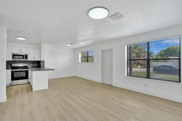 a view of kitchen with microwave and stove