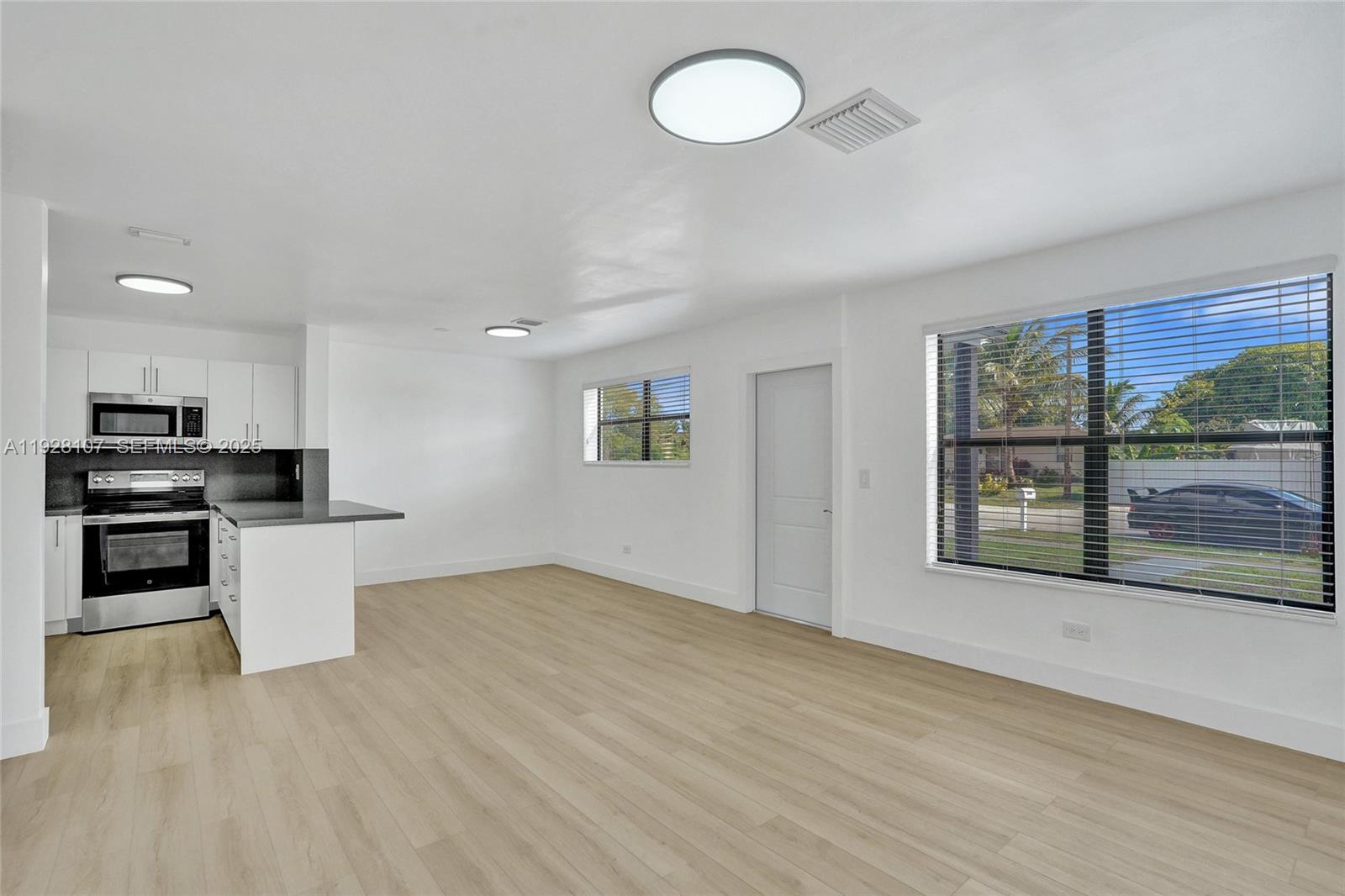 1960 Southwest 68th Way Miramar, FL 33023 - Photo 16 of 42 a view of kitchen with microwave and stove