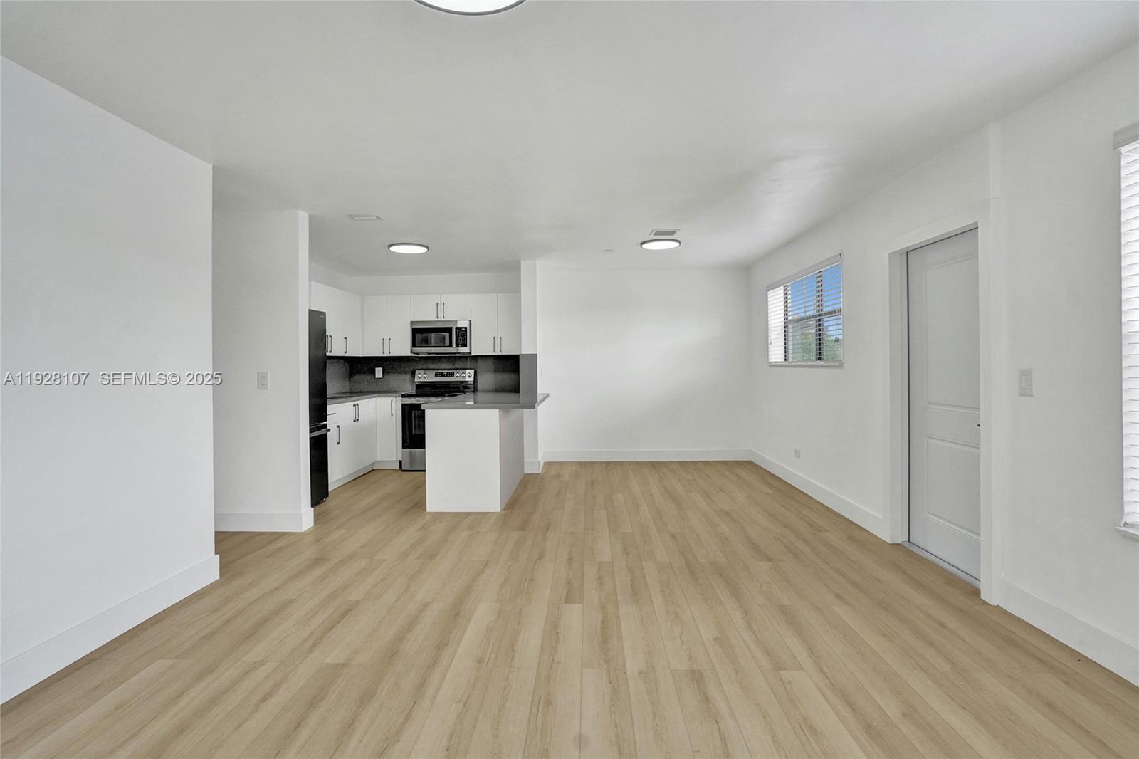 1960 Southwest 68th Way Miramar, FL 33023 - Photo 17 of 42 a view of kitchen with granite countertop cabinets and refrigerator