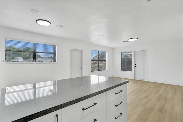 a view of cabinets with wooden floor and window