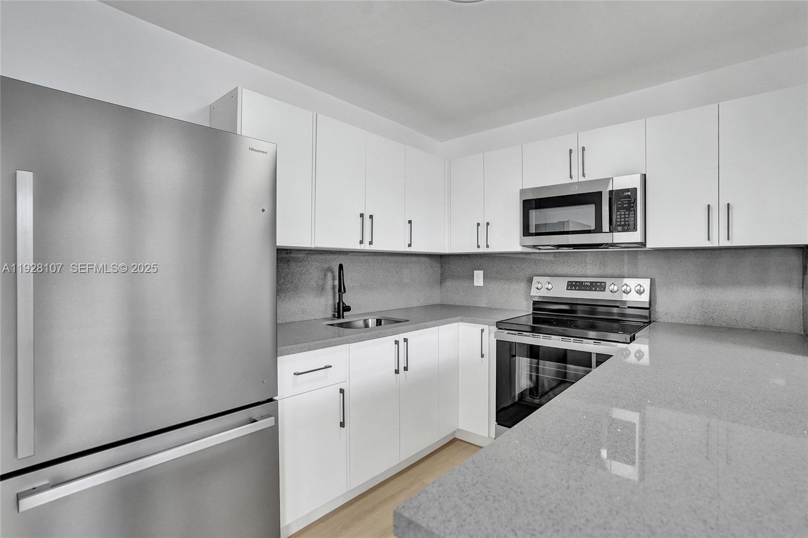 1960 Southwest 68th Way Miramar, FL 33023 - Photo 20 of 42 a kitchen with granite countertop white cabinets and stainless steel appliances