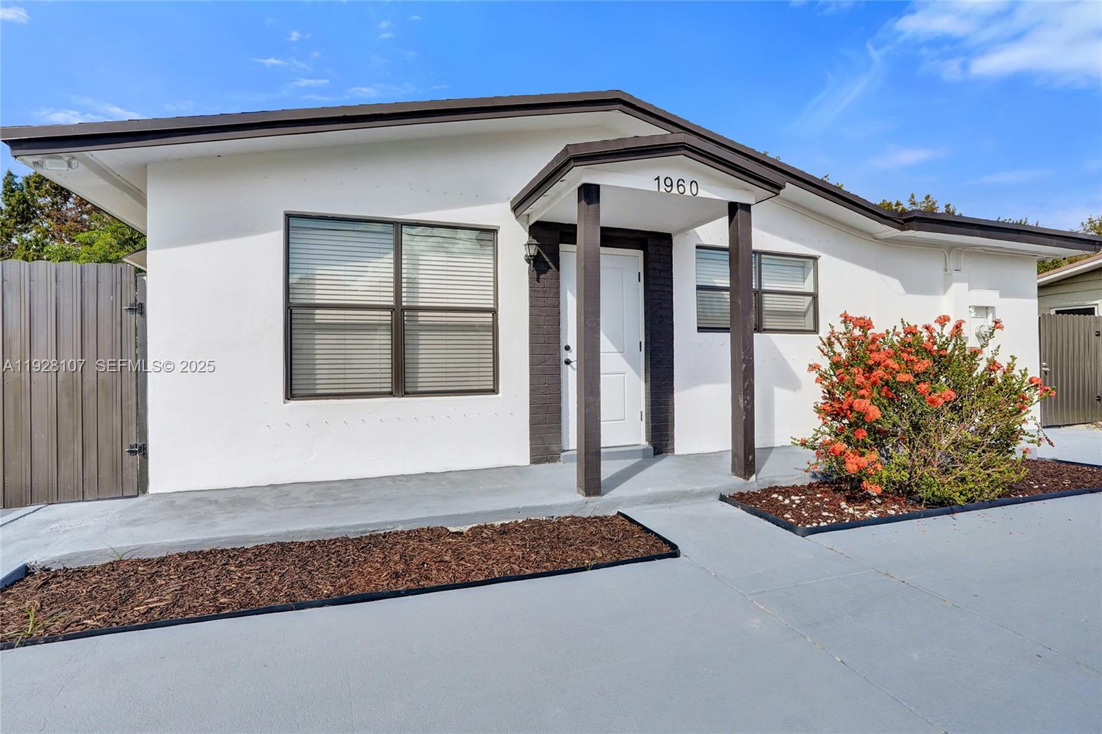 1960 Southwest 68th Way Miramar, FL 33023 - Photo 2 of 42 a front view of a house with garden