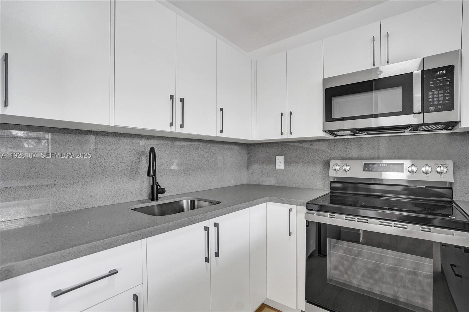 1960 Southwest 68th Way Miramar, FL 33023 - Photo 21 of 42 a kitchen with appliances a sink and cabinets