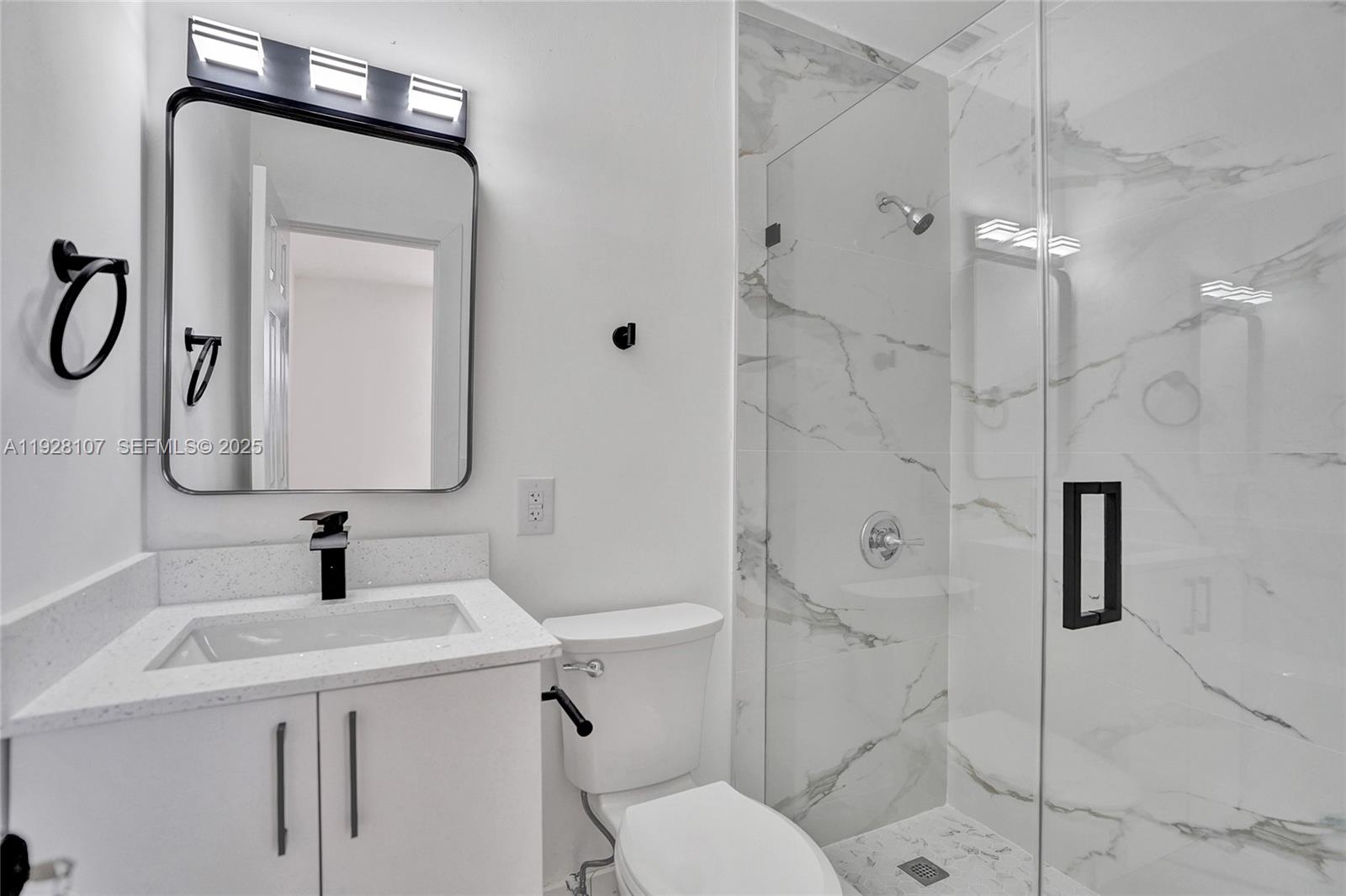 1960 Southwest 68th Way Miramar, FL 33023 - Photo 26 of 42 a bathroom with a sink a toilet and shower