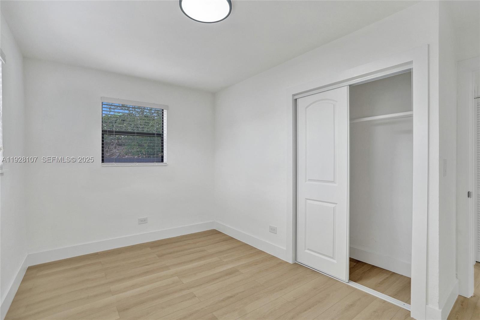 1960 Southwest 68th Way Miramar, FL 33023 - Photo 33 of 42 an empty room with wooden floor and window