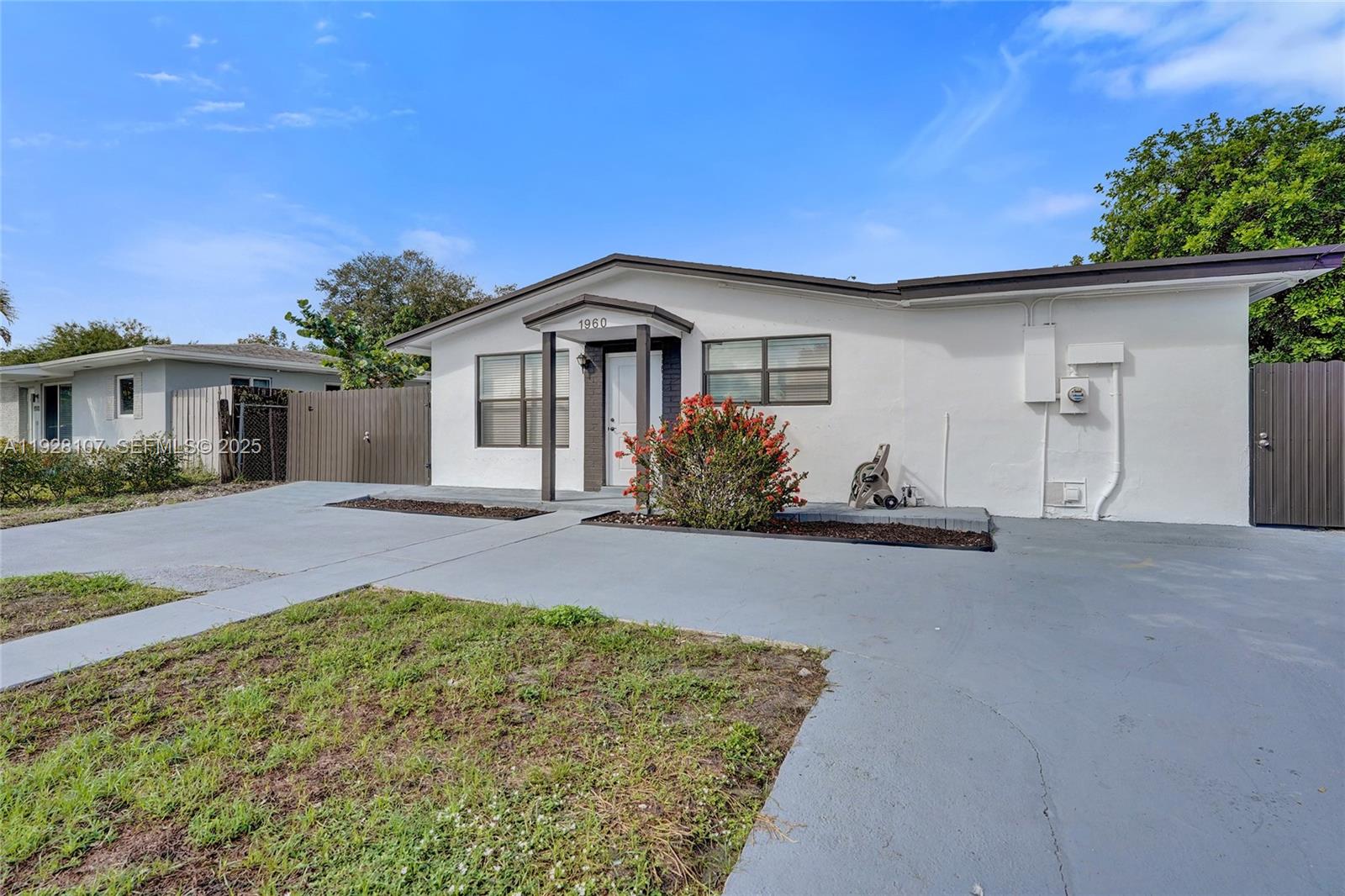 1960 Southwest 68th Way Miramar, FL 33023 - Photo 4 of 42 a front view of a house with a yard and garage