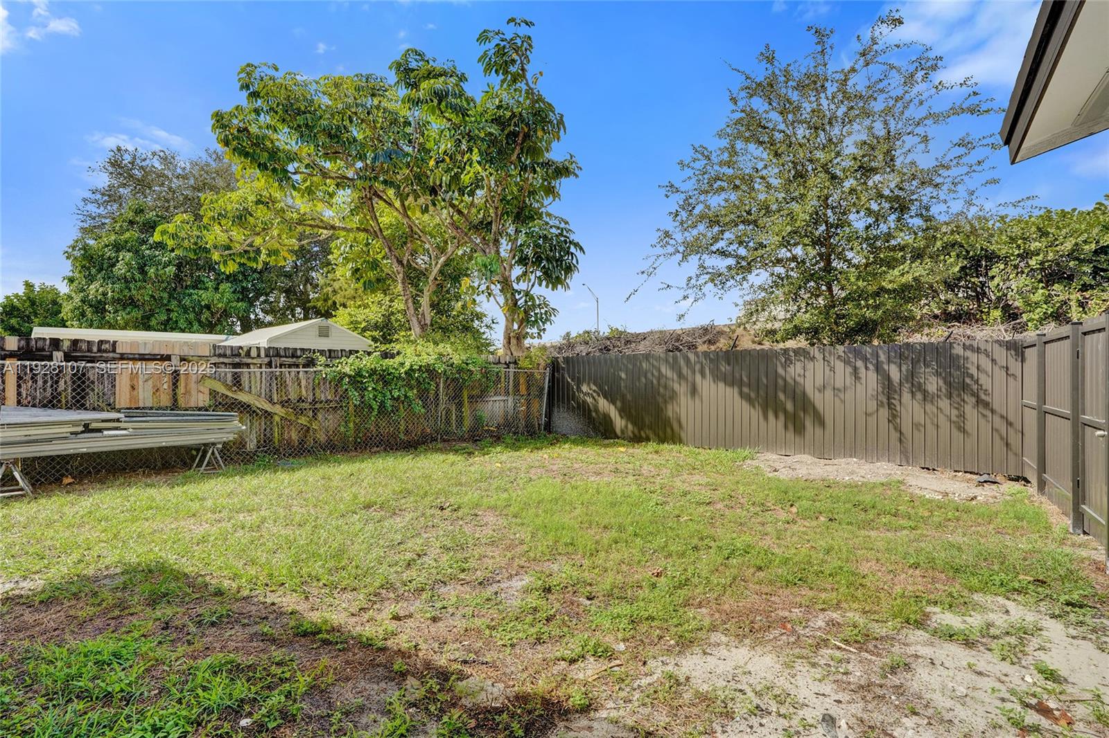 1960 Southwest 68th Way Miramar, FL 33023 - Photo 7 of 42 a backyard of a house with lots of green space