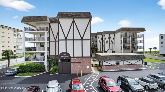 a view of a kitchen with wooden floor and electronic appliances
