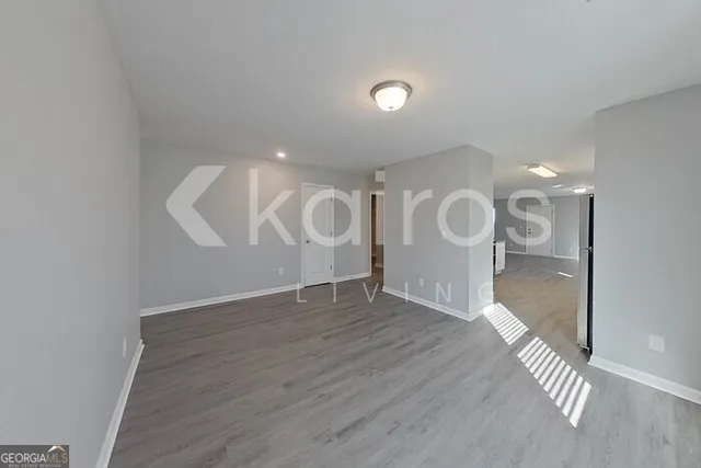 a view of a room with wooden floor and bathroom