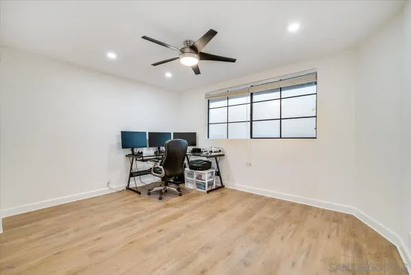 a view of workspace with wooden floor and windows