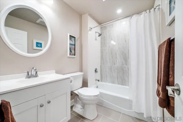 a bathroom with a toilet a sink and a mirror