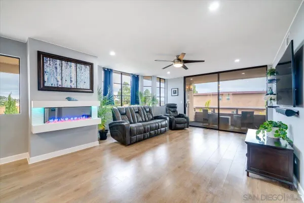 a living room with furniture fireplace and window