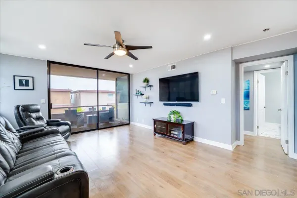 a living room with furniture tv and a flat screen tv