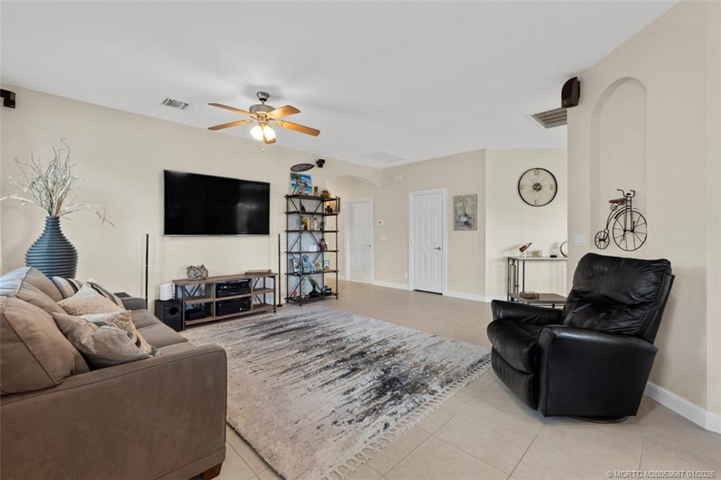 1171 Southeast Kirk Street Stuart, FL 34997 - Photo 17 of 47 a living room with furniture and a flat screen tv