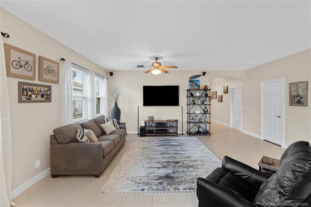 1171 Southeast Kirk Street Stuart, FL 34997 - Photo 19 of 47 a living room with furniture and a flat screen tv