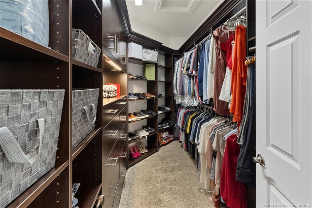 1171 Southeast Kirk Street Stuart, FL 34997 - Photo 24 of 47 a view of walk in closet with clothes and shoes