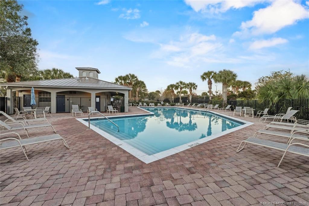 1171 Southeast Kirk Street Stuart, FL 34997 - Photo 37 of 47 a view of a house with a swimming pool