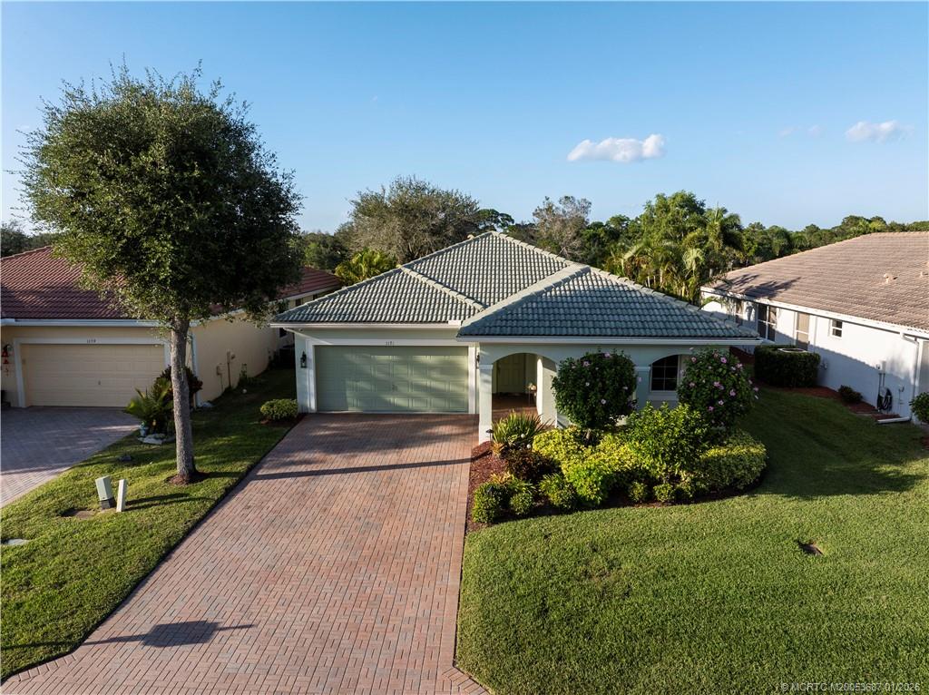 1171 Southeast Kirk Street Stuart, FL 34997 - Photo 4 of 47 a front view of a house with garden