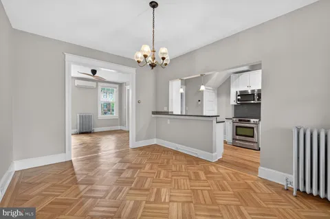 a view of an empty room with a chandelier