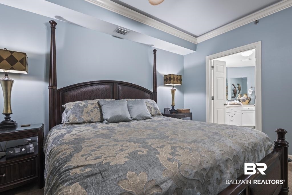 27582 Canal Road, Unit 2408 Orange Beach, AL 36561 - Photo 20 of 47 Bedroom with ensuite bathroom and crown molding