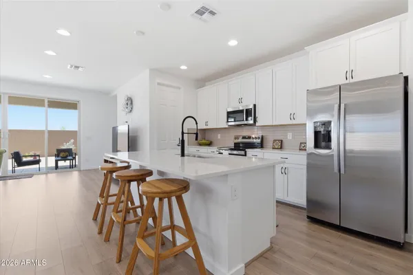a kitchen with stainless steel appliances a refrigerator sink and cabinets