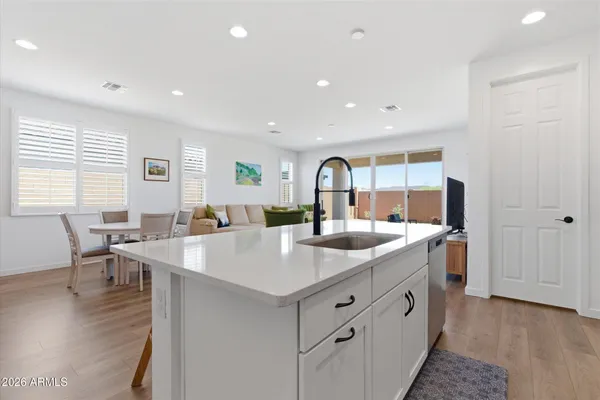 a open kitchen with stainless steel appliances granite countertop a sink and dishwasher with wooden floor