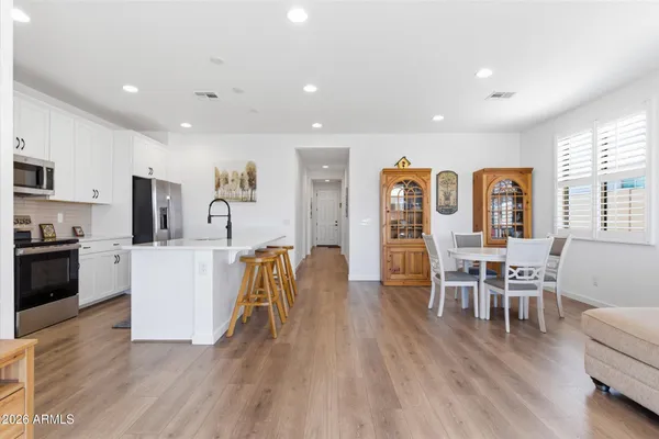 a living room with furniture and kitchen view