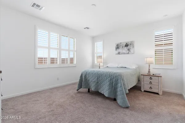 a spacious bedroom with a bed and a window