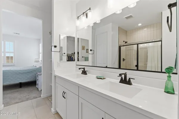 a bathroom with a sink double vanity and a mirror