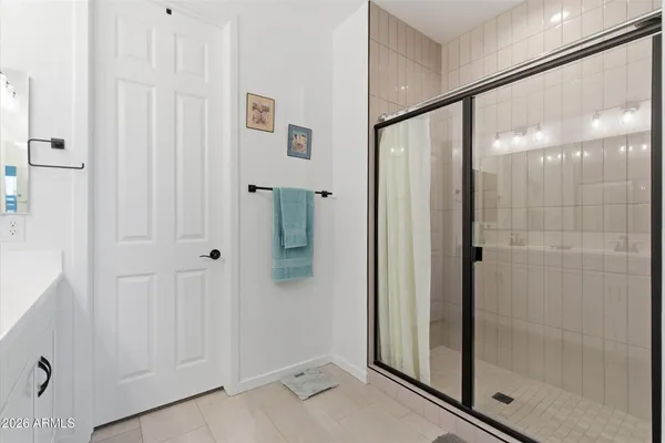 a bathroom with a glass shower door