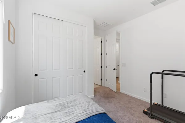 a bedroom with a bed and a mirror