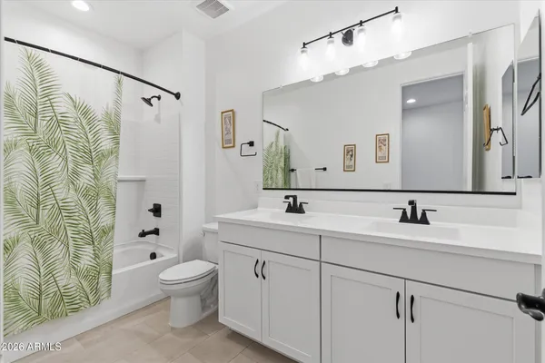 a view of a bathroom with sink mirror and wooden floor