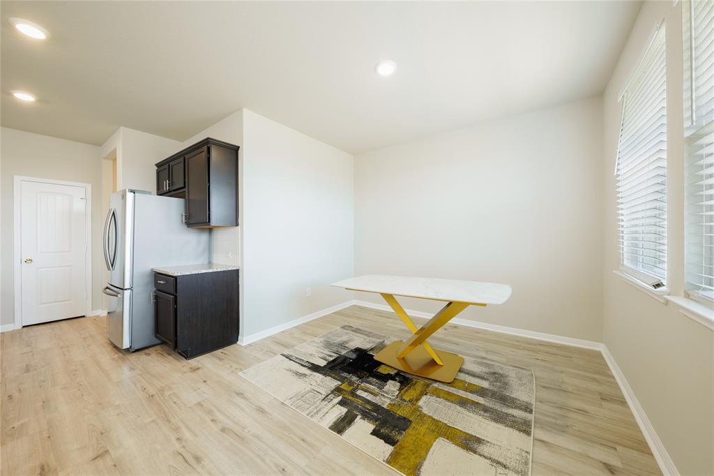521 Otto Avenue Georgetown, TX 78626 - Photo 9 of 38 Kitchen featuring light wood-type flooring, recessed lighting, freestanding refrigerator, and dark wood finish cabinetry