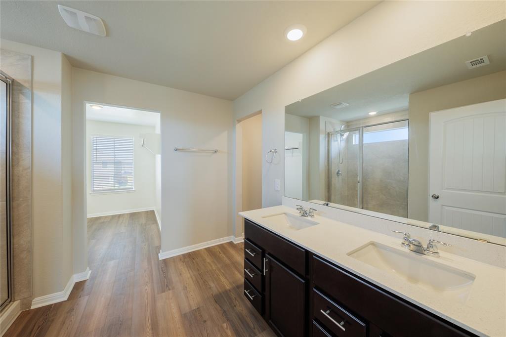 521 Otto Avenue Georgetown, TX 78626 - Photo 15 of 38 Bathroom with double vanity, a shower stall, dark wood-style floors, and recessed lighting