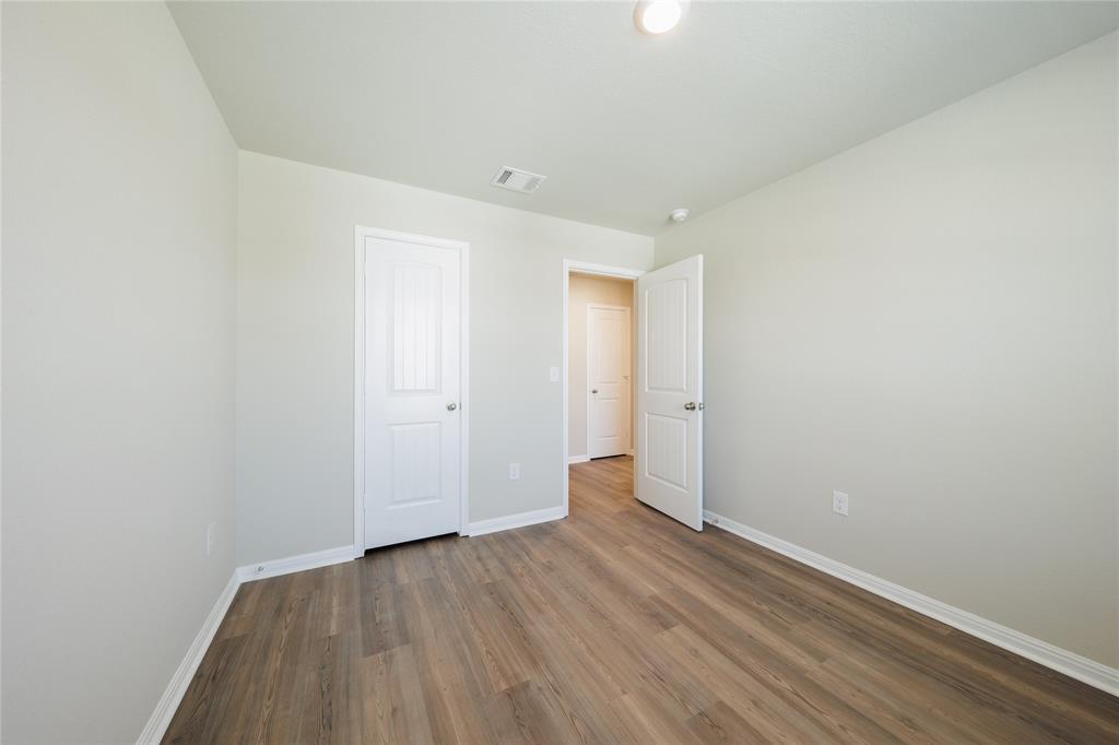521 Otto Avenue Georgetown, TX 78626 - Photo 19 of 38 Unfurnished bedroom featuring baseboards and wood finished floors
