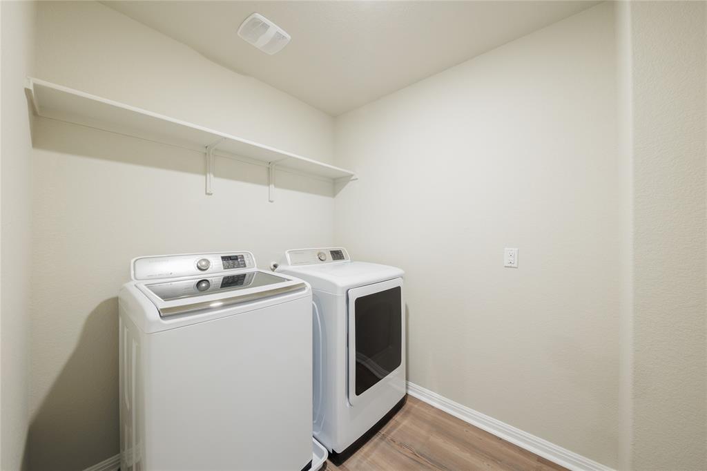 521 Otto Avenue Georgetown, TX 78626 - Photo 20 of 38 Laundry room featuring light wood-style flooring and separate washer and dryer