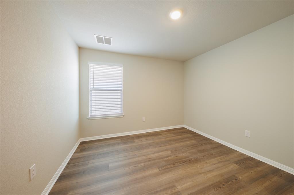 521 Otto Avenue Georgetown, TX 78626 - Photo 24 of 38 Spare room featuring wood finished floors and baseboards