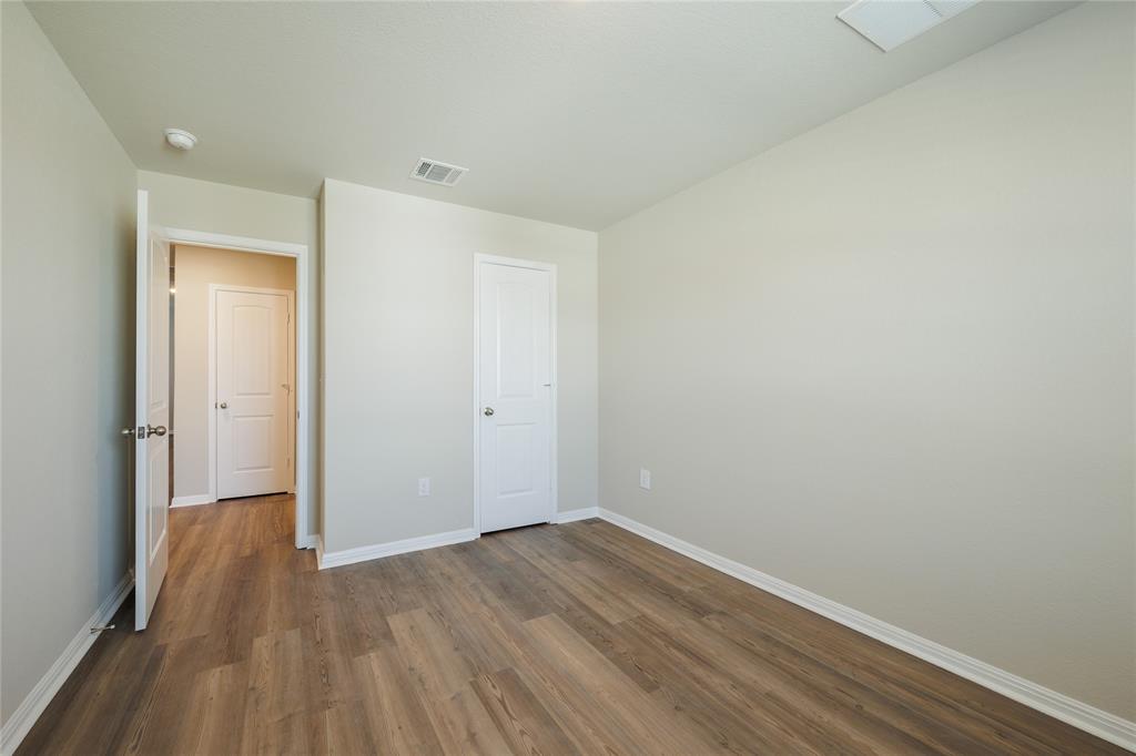 521 Otto Avenue Georgetown, TX 78626 - Photo 26 of 38 Unfurnished bedroom featuring dark wood-style flooring and baseboards