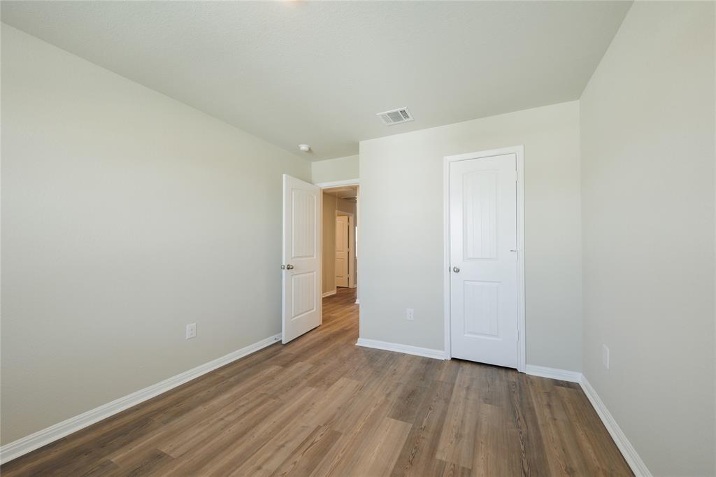 521 Otto Avenue Georgetown, TX 78626 - Photo 27 of 38 Unfurnished bedroom featuring wood finished floors and baseboards