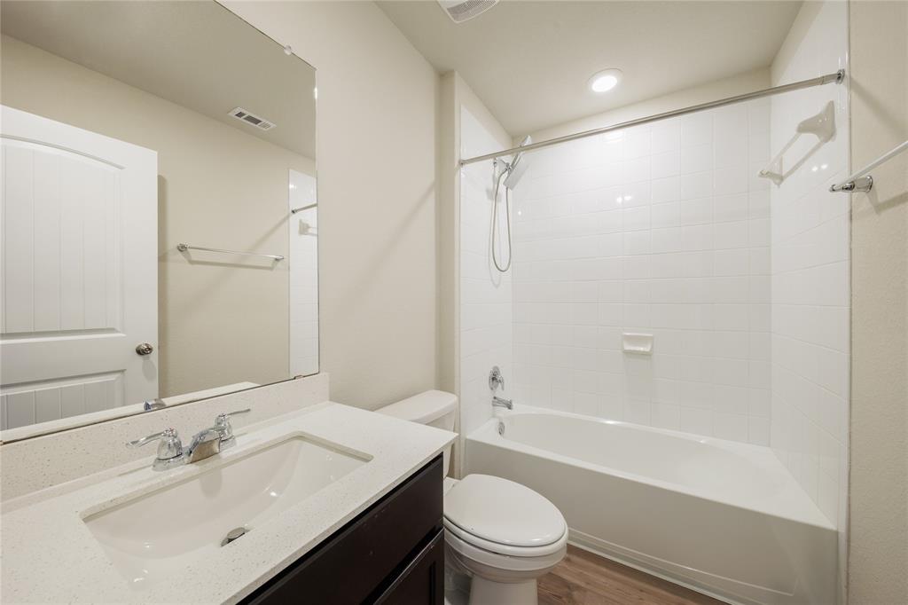 521 Otto Avenue Georgetown, TX 78626 - Photo 28 of 38 Bathroom featuring bathtub / shower combination, vanity, and dark wood-style flooring