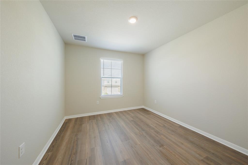 521 Otto Avenue Georgetown, TX 78626 - Photo 31 of 38 Spare room featuring wood finished floors and baseboards